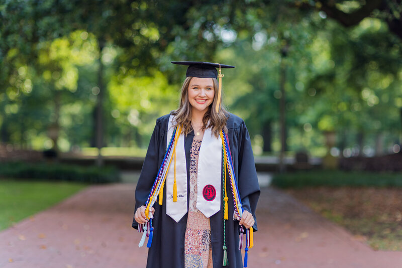 A girl posing for her senior portraits on the University of South Carolina's campus