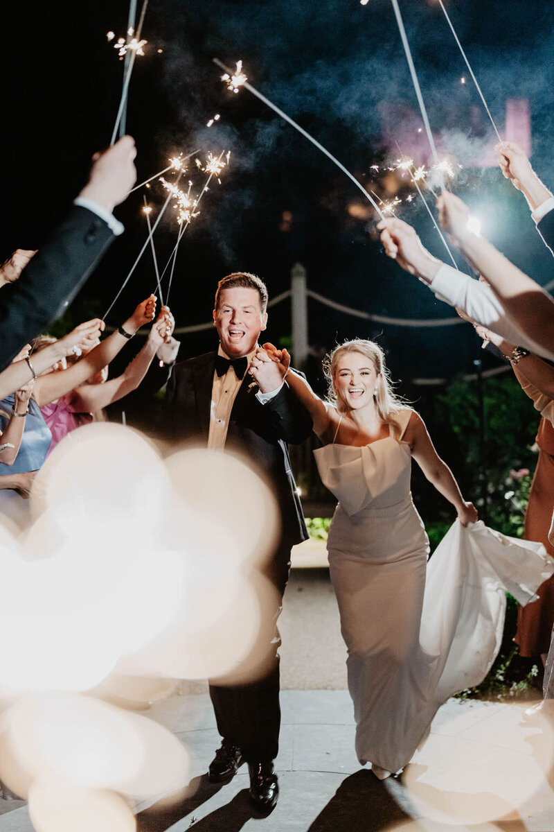 Bride and groom leaving their wedding with a sparkler exit