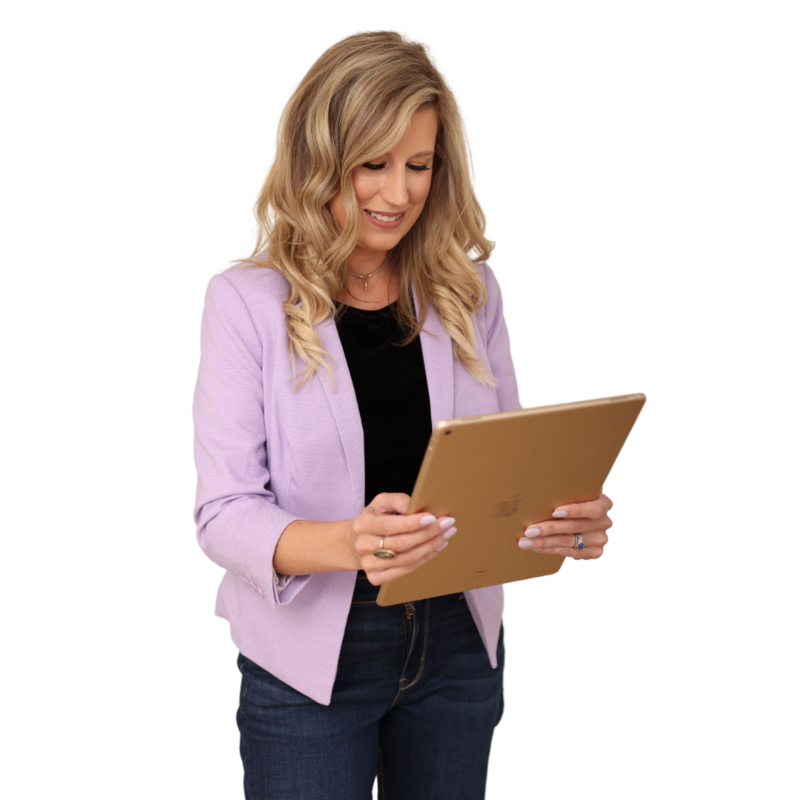 A Showit website designer in business attire, reviewing a website on a tablet as part of a creative design process.