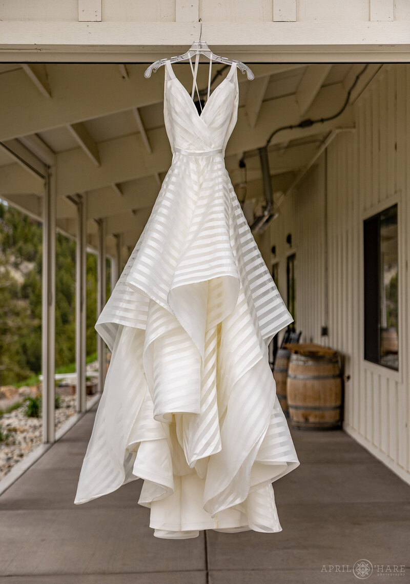 Wedding Dress Hanging on the Covered Patio at the Barn at The Woodlands in Colorado