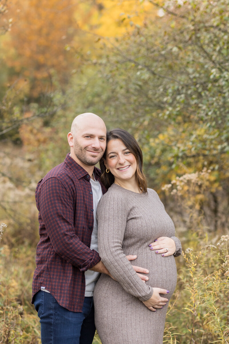 Man and woman posing for maternity photography in Southfield MI