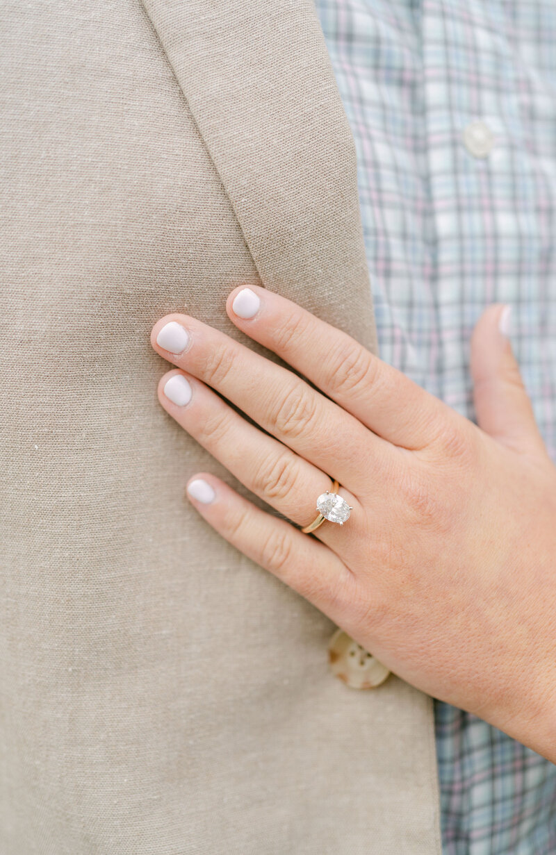 wedding rings sitting on top of a wedding invitation