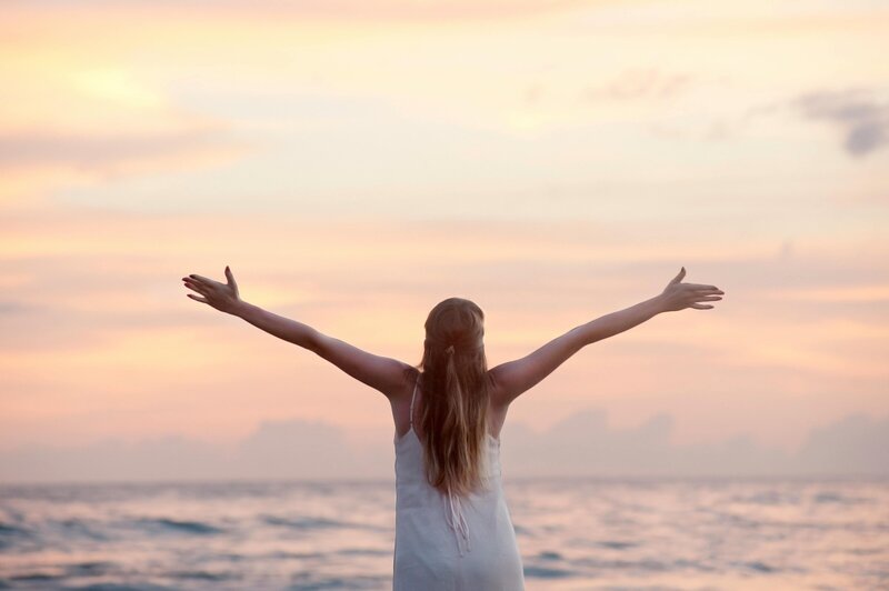 Women with arms spread wide open