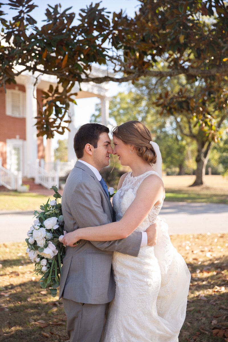 Newly weds smiling at each other at Heritage House after their wedding.