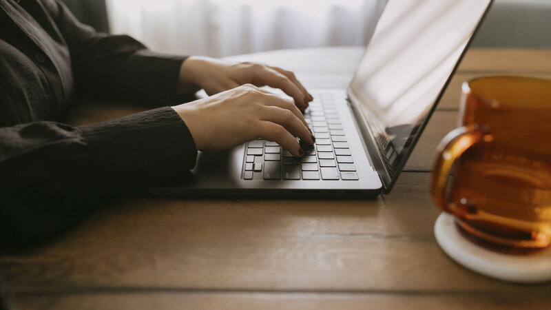 Renee typing on laptop