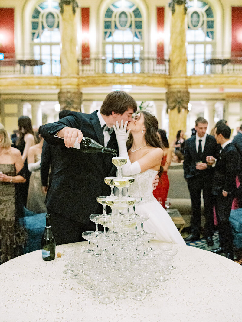 Bride and groom pouring champagne tower at a multi-day wedding celebration, captured by Seattle and DC wedding photographer.