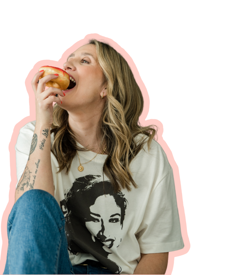 Professional brand design expert in colorful branded outfit taking a creative break with a red donut.