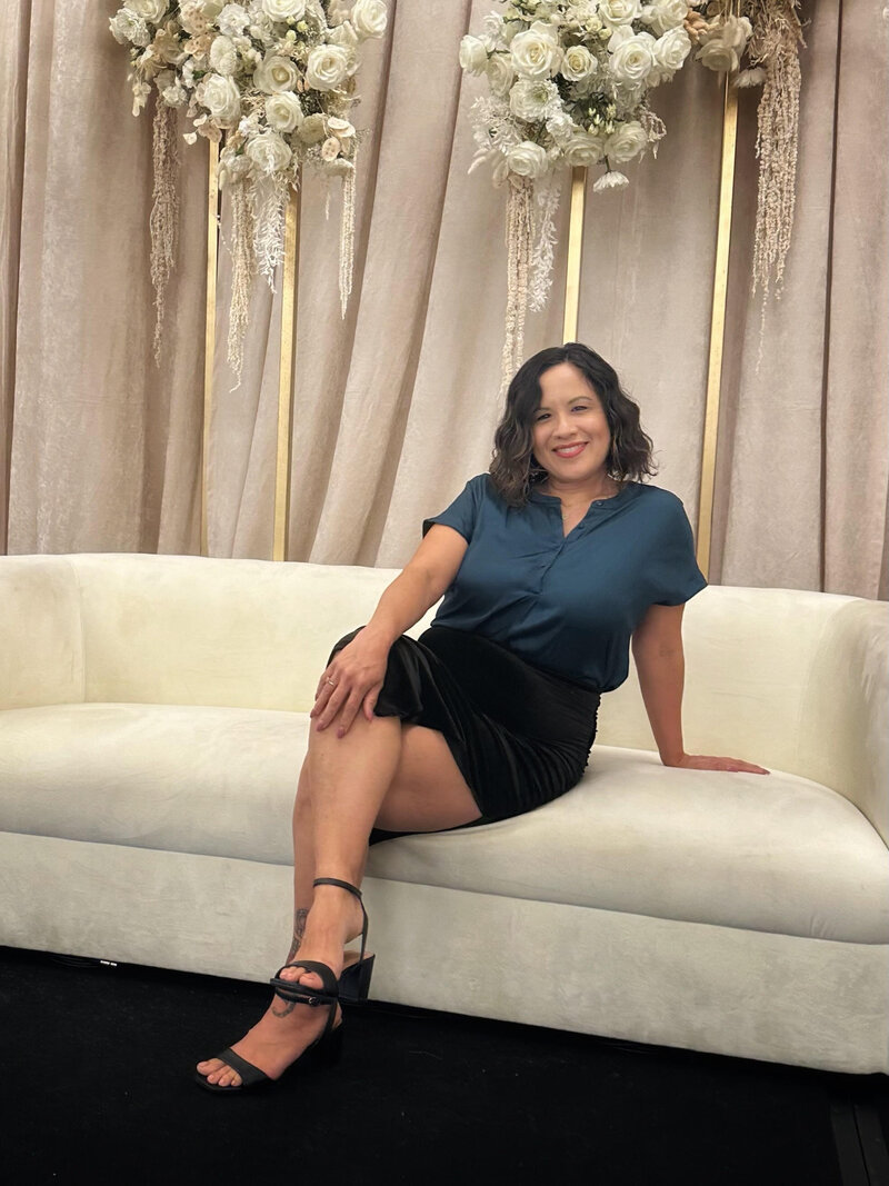 woman posing in a hotel lobby in fron of elevator