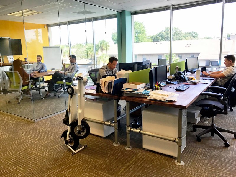 Office worker with white Go-Bike M1 at his desk