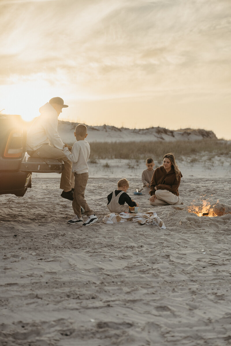 Family sitting around a beach bonfire. Maternity photographers nj, New Jersey Family photographers