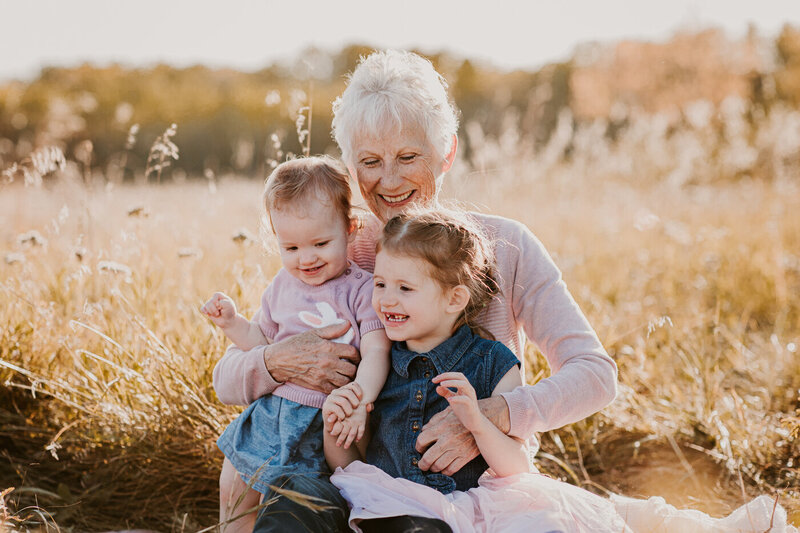 candid family moment with young girl and her mom and grandma in Winnipeg 