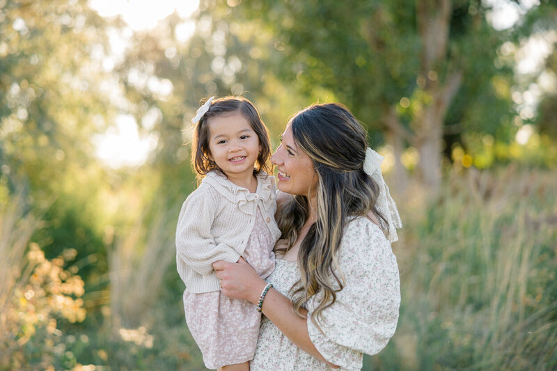 mom holding toddler daughter