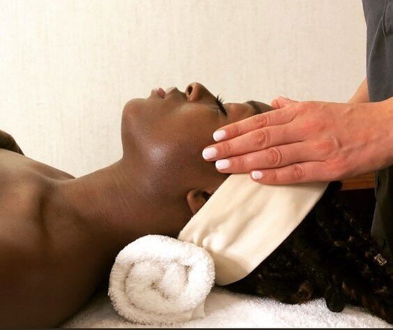Peaceful facial treatment with soft touch, celebrating nurturing care for mothers and women.