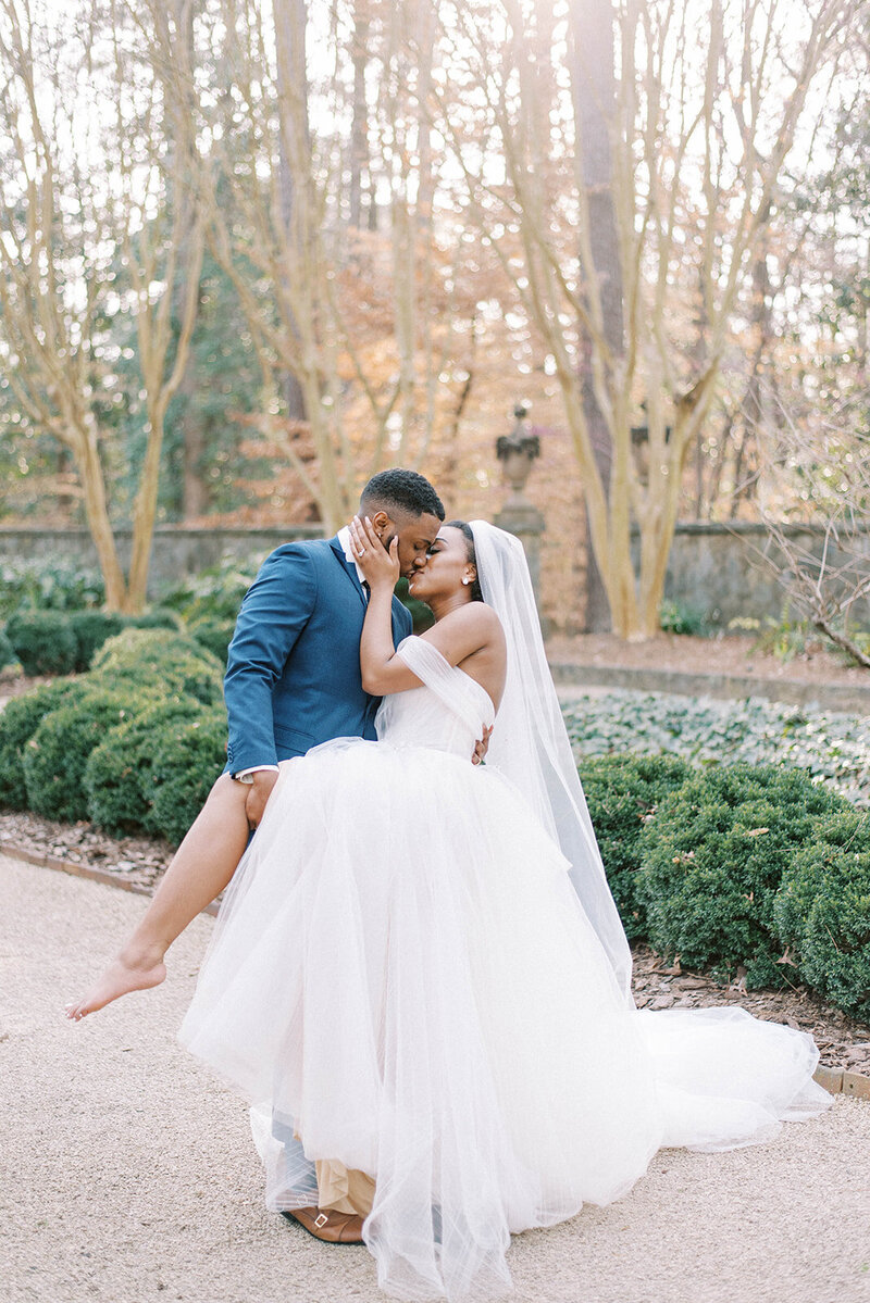 bridal couple kissing on wedding day in Florida at Swan House