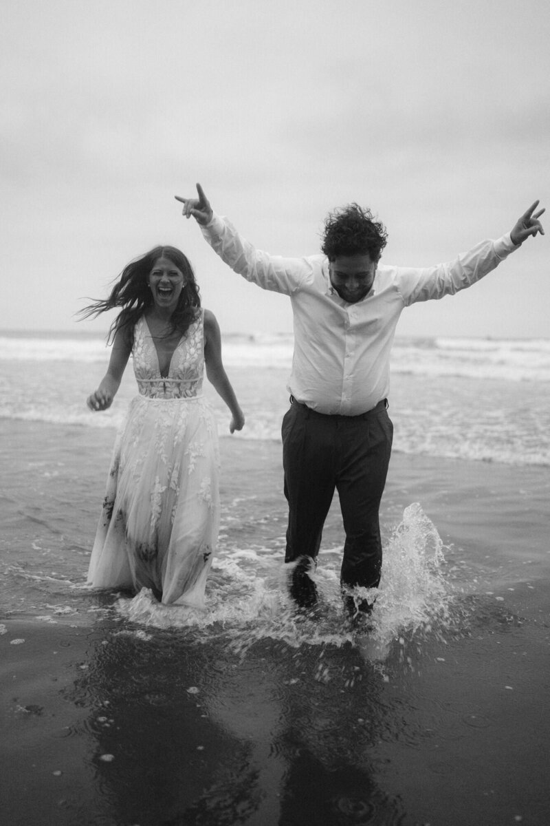Bride and groom pop champagne on the edge of a cliff after they got their Yosemite Wedding Permit 