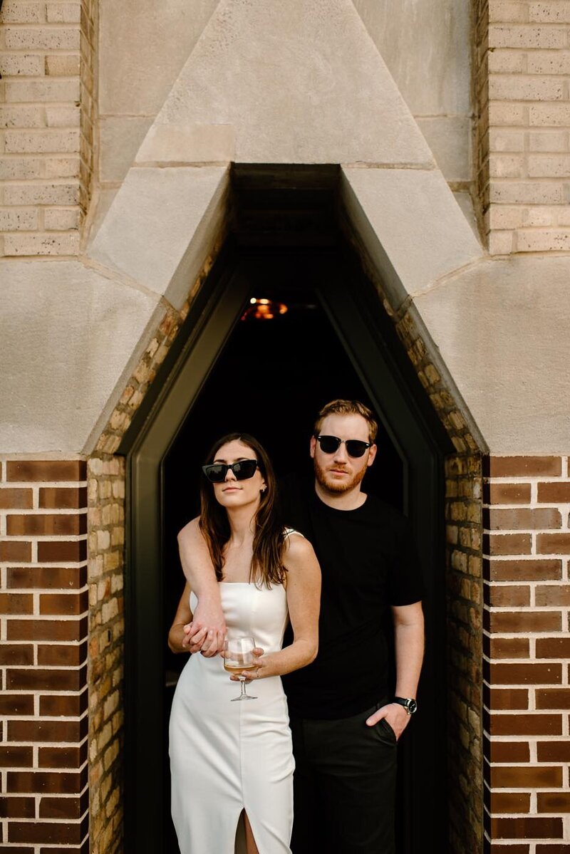 couple in sunglasses and looking at photographer