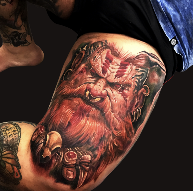A fierce Viking demon tattoo featuring a menacing figure with horns protruding from its nose, combining elements of Norse mythology and dark fantasy. The design showcases intricate details of the demon’s facial features, including sharp horns, fierce eyes, and a rugged, battle-worn appearance, symbolizing power, aggression, and supernatural strength. The tattoo’s bold lines and shading create a dramatic, intimidating effect.