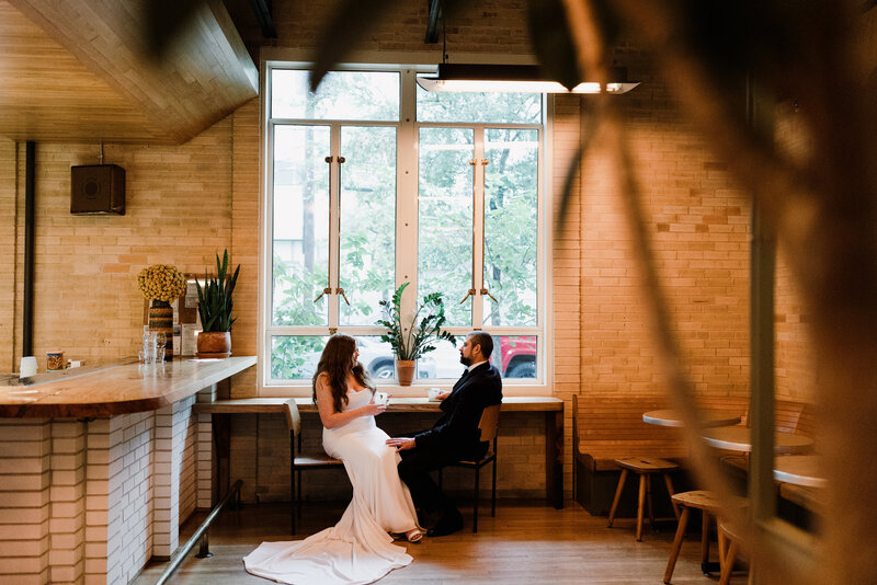 Couple sitting on front steps of a house kissing, Austin elopement wedding