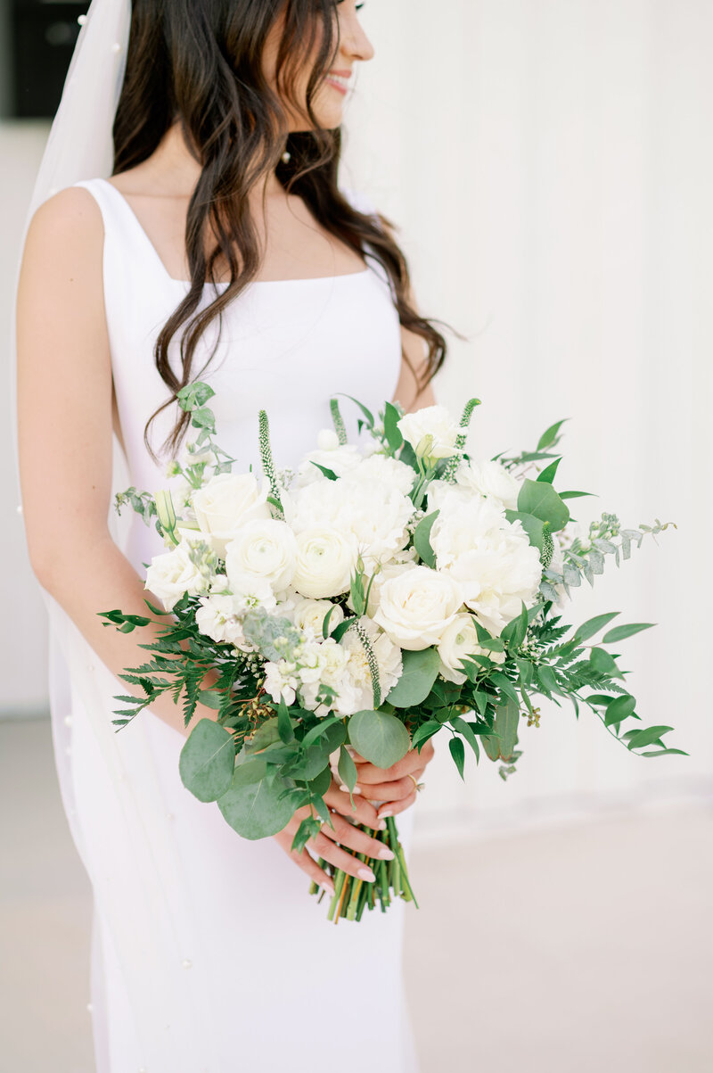 a bride holding a flower bouquet for her Notre Dame wedding
