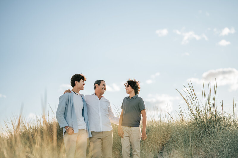 family of 5 sitting on blanket in the field