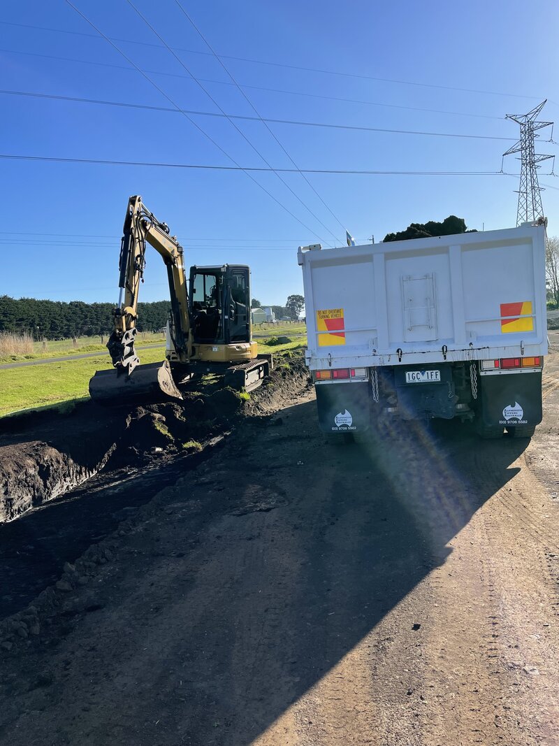 Excavator digging road drainage