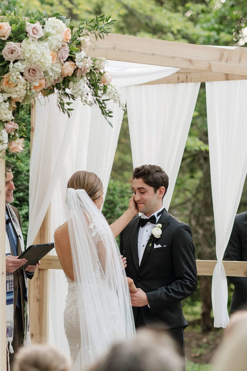 emotional moment between bride and groom at the alter at riverwood mansion in nashville