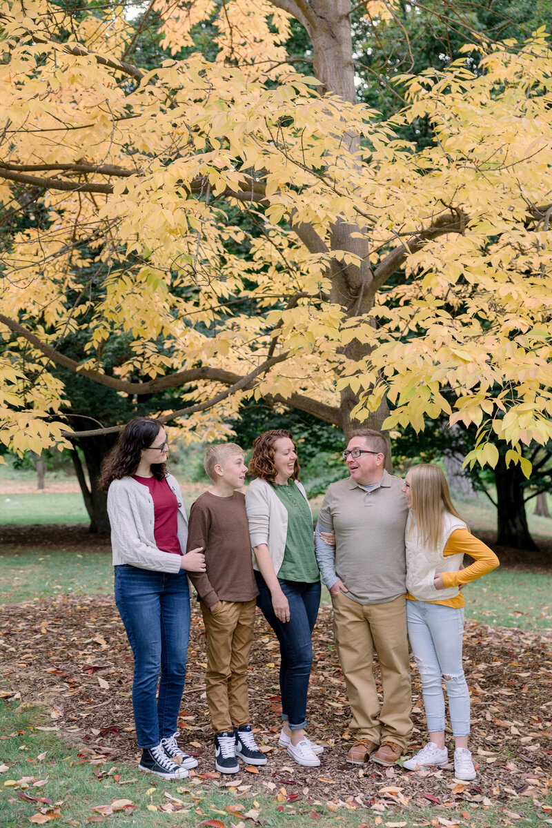 family smiling at each other at Finch arboretum taken by spokane family photographer