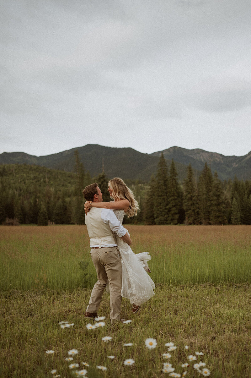 Bride and groom sharing a romantic moment during their mountain elopement in Montana