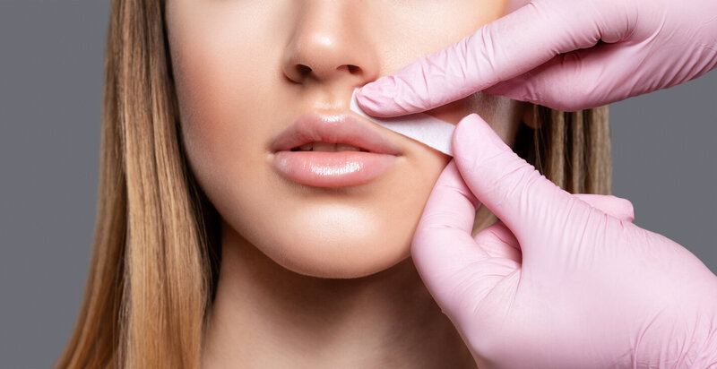 Leg waxing procedure in progress during full-body waxing treatment at Gloss RVA Med Spa