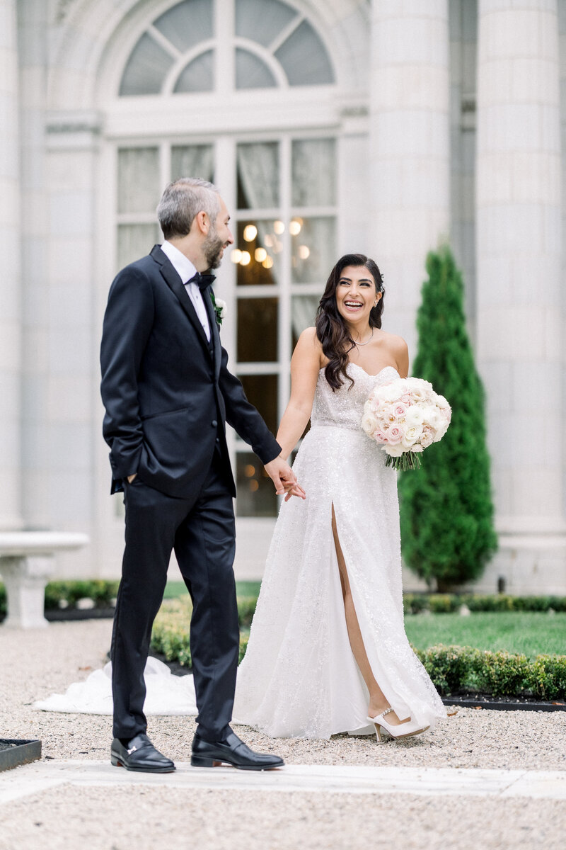 bride and groom walking outside of Rosecliff mansion in Newport Rhode Island