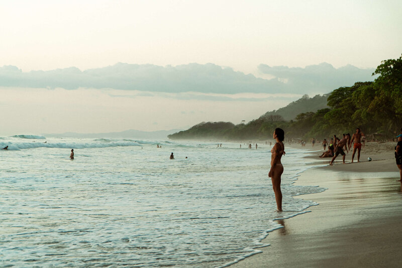 Woman standing in front of ocean.