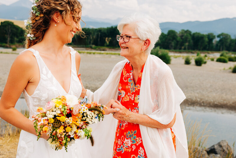 Bride holding grandma's hand at Miles Park Band Shell in Livingston, MT