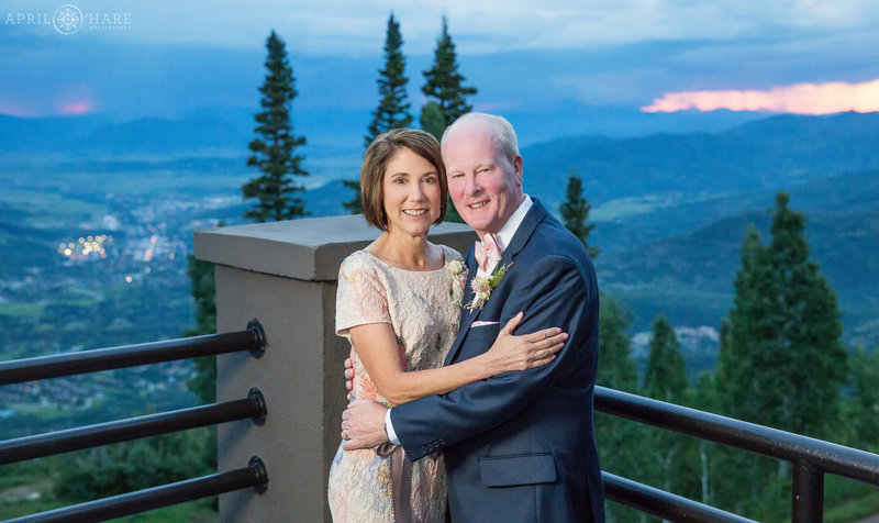 Parents of the bride get a sunset photo on the deck outside of Champagne Powder Room at Steamboat Springs Resort