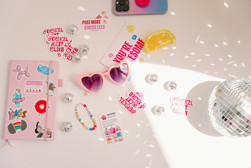 Hand with a pink sleeve holding up a phone with an Instagram grid on the screen