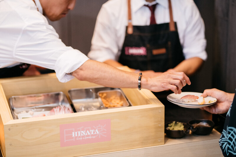 Sushi chef serving sushi