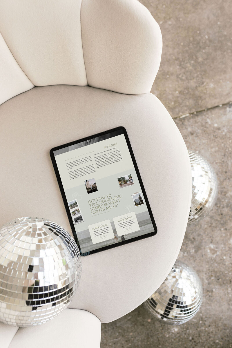 Showit website template for elopement photographers shown in an iPad laying on a couch