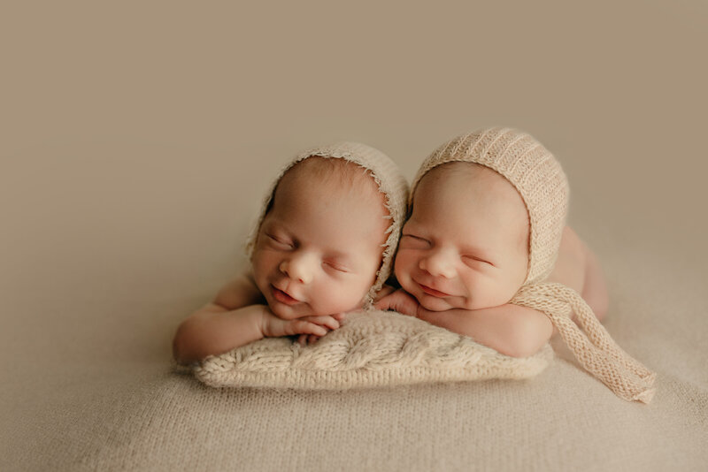 Smiling twin newborn identical boys