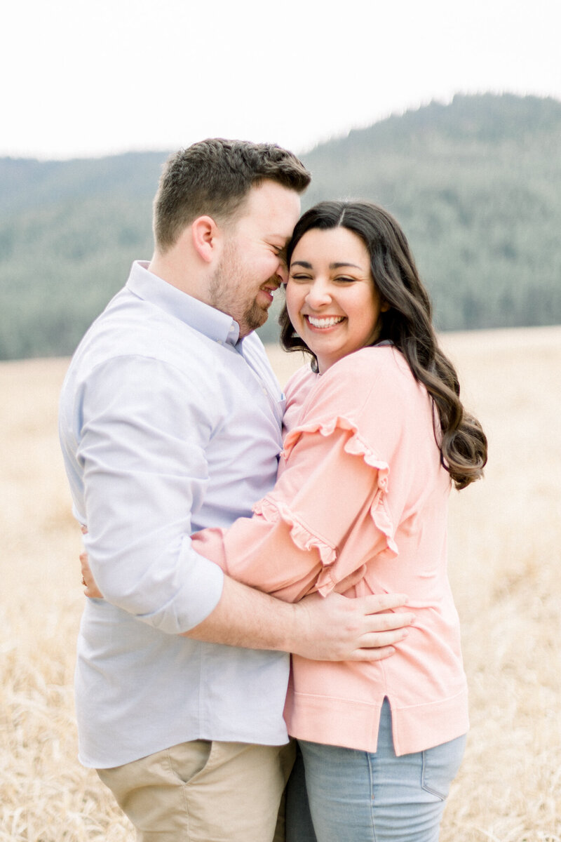 couple hugging and laughing taken by spokane engagement photographer