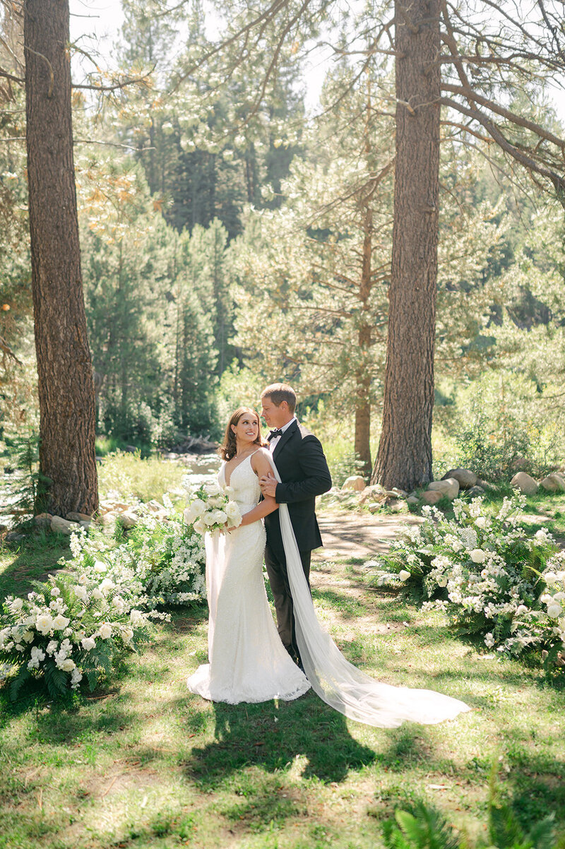 Bride and Groom standing in a meadow at Dancing Pines Wedding Venue in Truckee, CA.