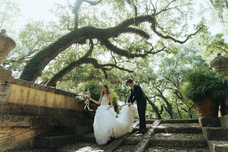 bride and groom on stairs in the forest captured by destination and mexico wedding photographer elsie goodman