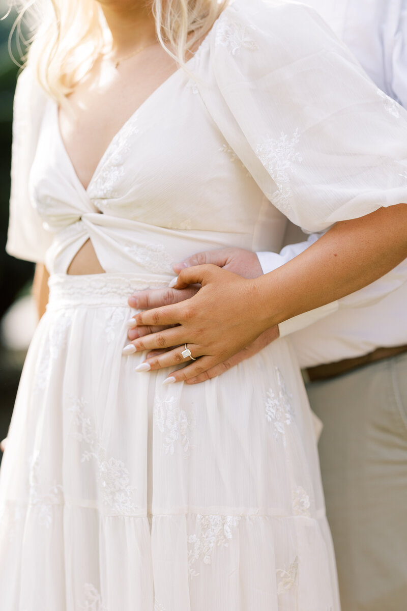 close up of a woman wearing an off-white dress for an engagement photoshoot