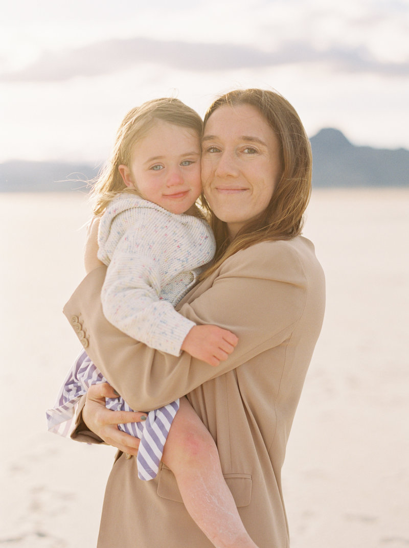 family photographer with daughter at waterfall