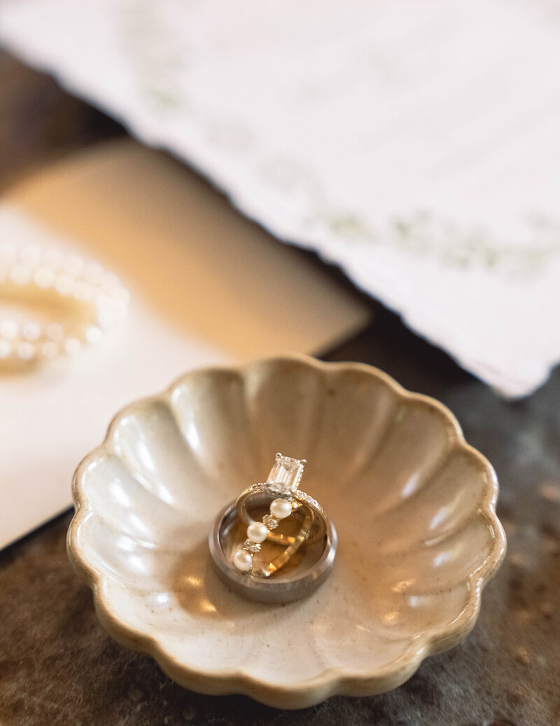 White roses with bride and groom wedding bands