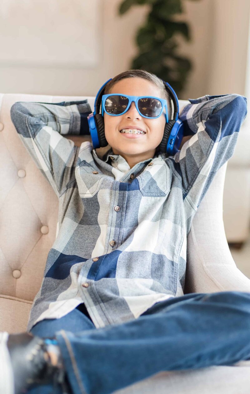 Kid in Frisco TX Thrive Dental with blue headphones