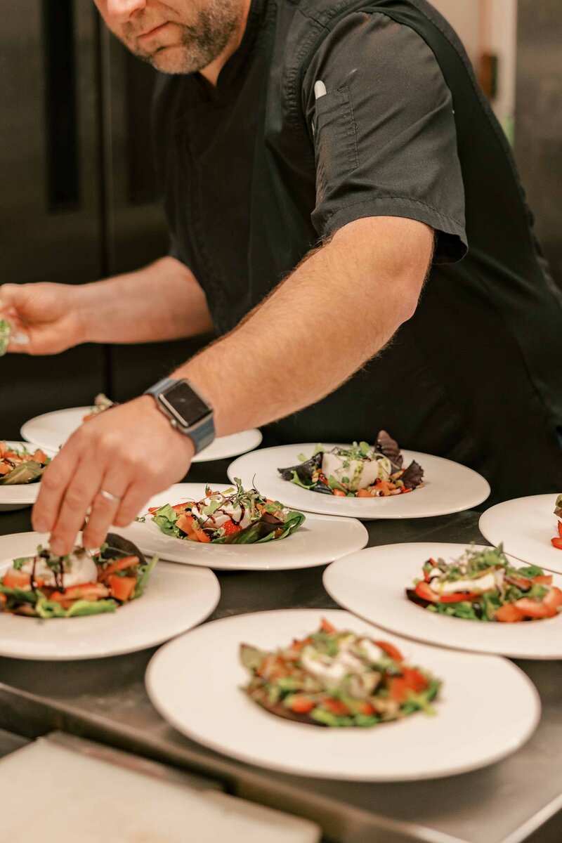 Chef Julien setting plates of balsamic strawberry salads