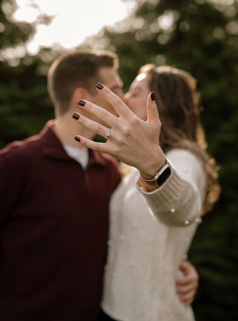 Couple celebrating their engagement and showing off the ring during a photoshoot in New York City