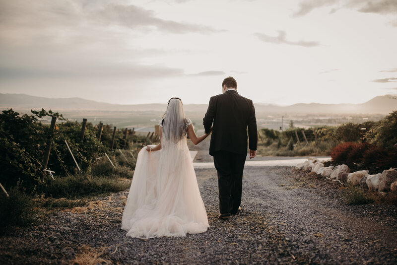 bride and groom walking on gravel road