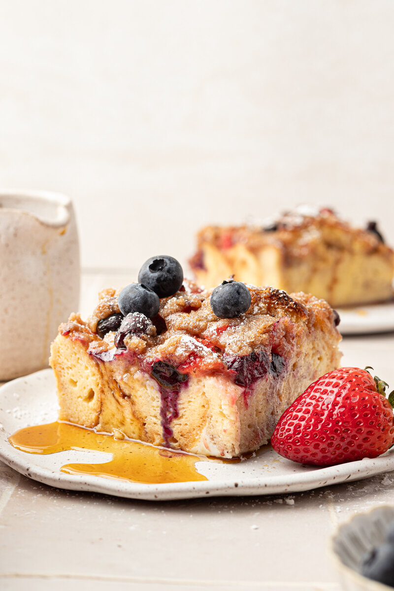 a plate of french toast topped with blueberries