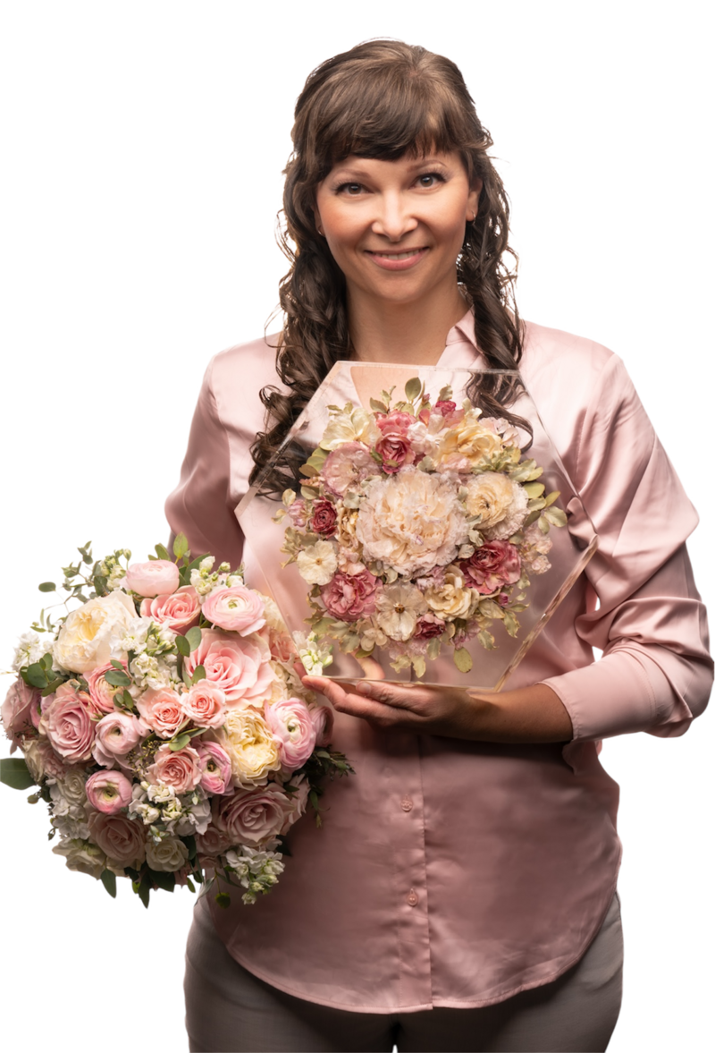 lady holding both a fresh bouquet as well as a beautifully preserved bridal bouquet