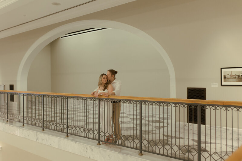 engagement session located in nashville tennessee where male is kissing his fiance on the head while she closes her eyes